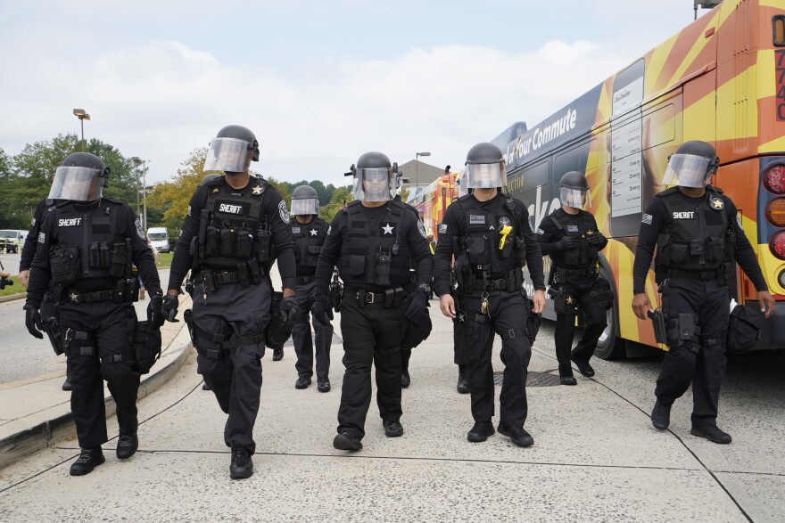 Law enforcement officers arrive at the Vienna metro station in Vienna, Va.
