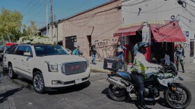 A police officer escorts the car carrying the remains of who authorities identified as the late Jalisco New Generation Cartel leader Nemesio Oseguera, alias "El Mencho," to Recinto de Paz cemetery for burial in Guadalajara, Mexico, Monday, March 2, 2026. (AP Photo/Refugio Ruiz)