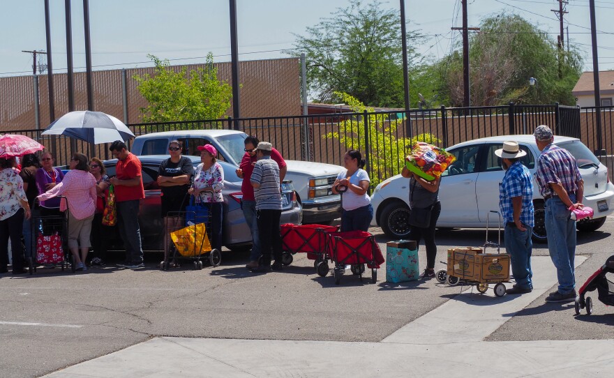 Every month, a food bank is set up at the community center in Heber, and some 250 families line up for free food.