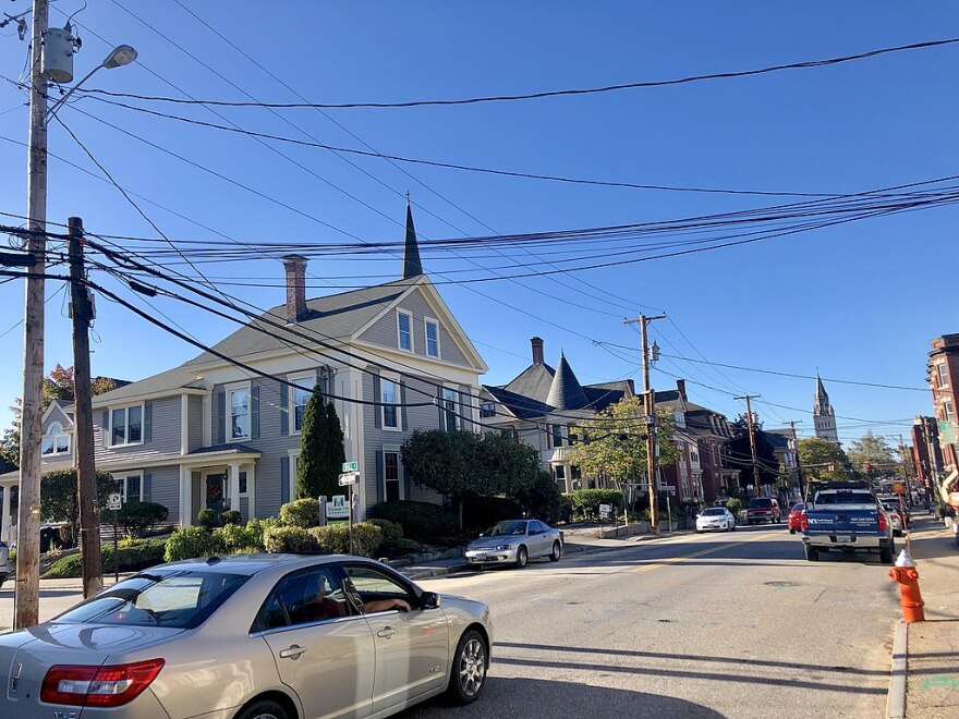 A view of State Street in Concord shows a car passing by residential-looking buildings