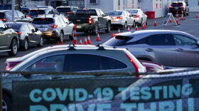 Cars wait in line at a COVID testing site in Covington, Ky., Monday, Jan. 3, 2022. (AP Photo/Jeff Dean)