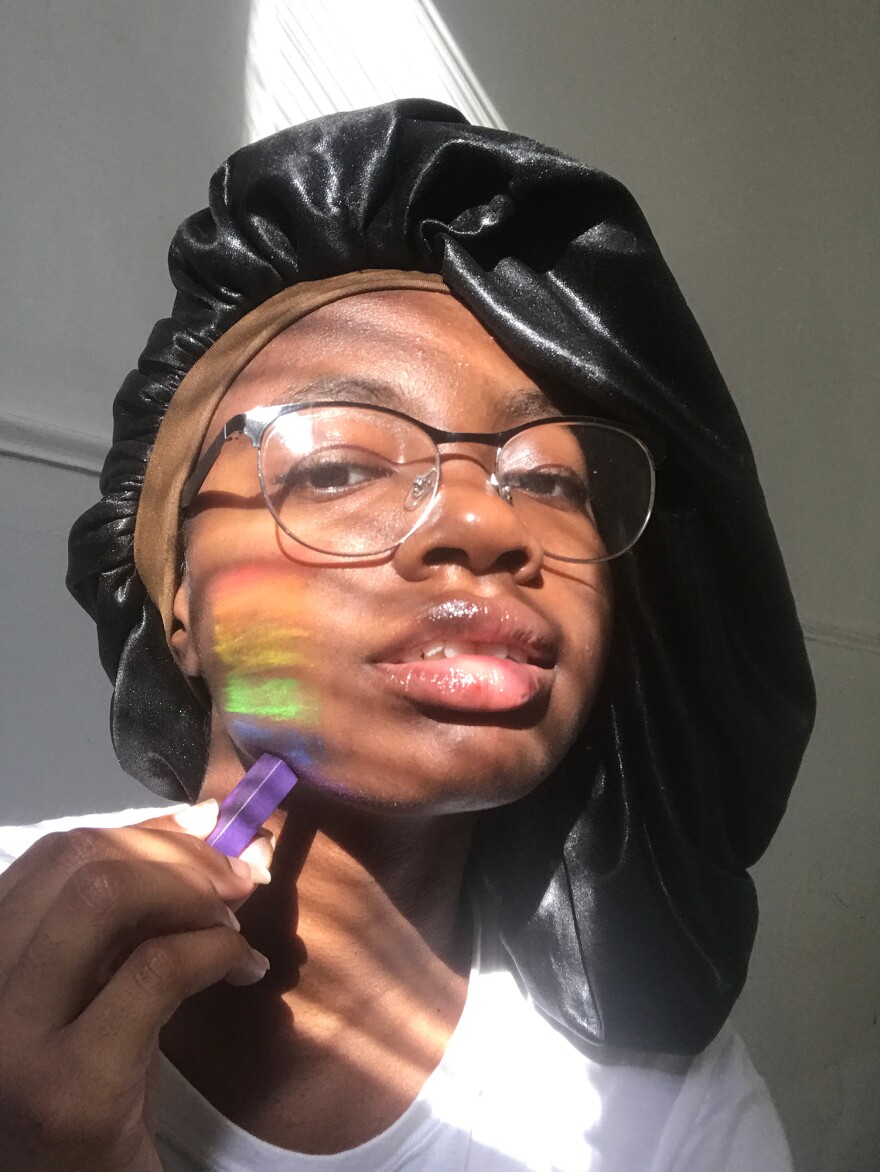 "This was for the portrait assignment, and I didn't want to just take a picture of my face, because I thought it would be boring. So I had charcoal pastels and I put them on my face and made a rainbow, while also taking the picture in the sunlight."