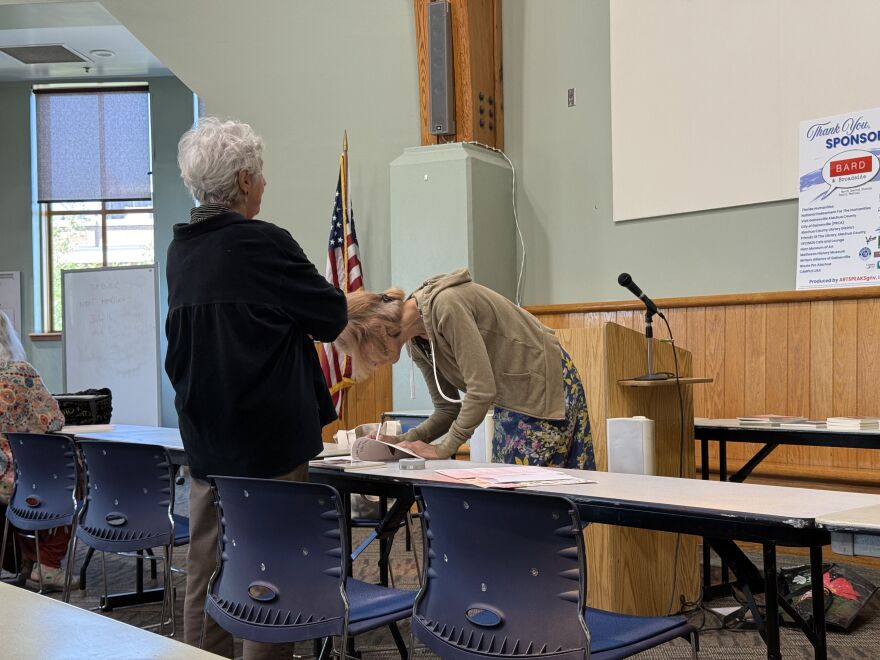 Loye Barnard gets her book signed by Lola Haskins. “She’s such an amazing spirit of all of Earth and the universe.” (Hannah Getman/WUFT News)