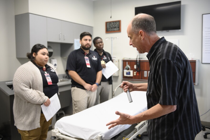 Students at the Hunt School of Nursing react to paid actor Gary Gillette, who is simulating an irate medical patient as part of the training program to prevent workplace violence against health care workers.