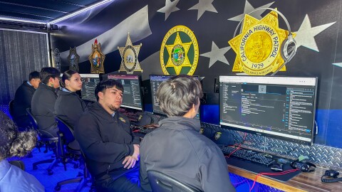 Criminal justice students at Matilda Torres High School debrief their phone call scenario with one another.