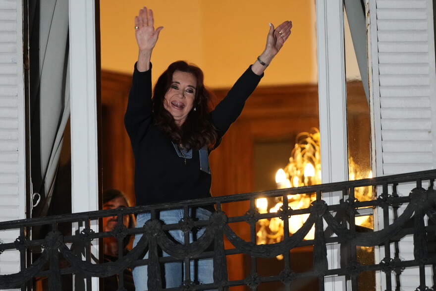 Former Argentine President Cristina Fernandez, who is serving a prison sentence under house arrest for corruption, waves from the balcony of her home during a rally marking the fourth anniversary of the assassination attempt against her in Buenos Aires, Argentina, Tuesday, Sept. 1, 2026.