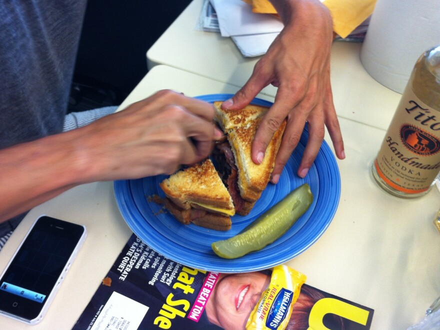 Ian cuts the sandwich into five healthy 1000 calorie bites.