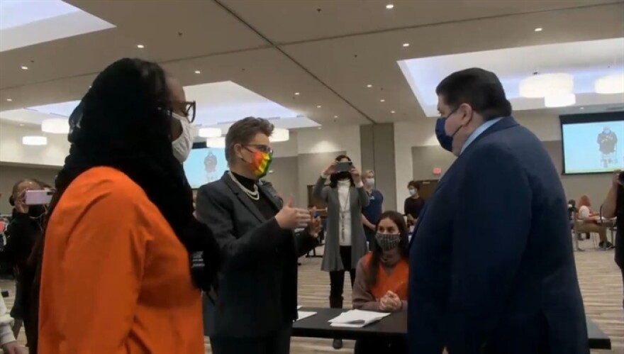 Dr. Julie Pride, center, administrator of the Champaign-Urbana Public Health District, gives Gov. JB Pritzker and state Sen. Carol Ammons a tour of the area's new COVID-19 vaccination center during a media event Wednesday.