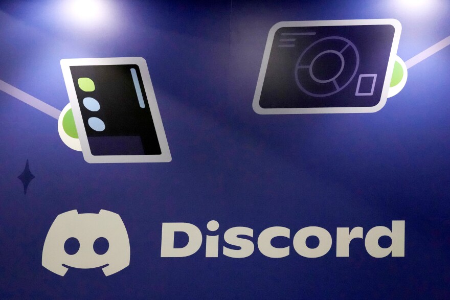 FILE - A Discord display stands at the company's booth at the Game Developers Conference 2023, in San Francisco, March 22, 2023.