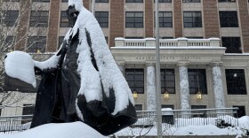 A snow-covered statue of William Henry Seward stands in front of the Alaska State Capitol on Wednesday, March 4, 2026.