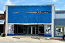 An empty store front in Osawatomie, Kansas, shows photos of Teddy Roosevelt and Barack Obama