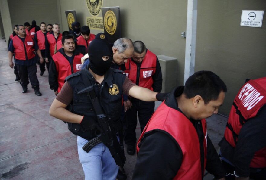 The warden and guards of the Apodaca prison are escorted away after a press conference in Monterrey, Mexico, Feb. 22. The director, deputy director and the chief of security along with 26 guards are under arrest for allegedly assisting members of the Zetas drug cartel orchestrate an escape and the killing of members of the rival Gulf cartel.