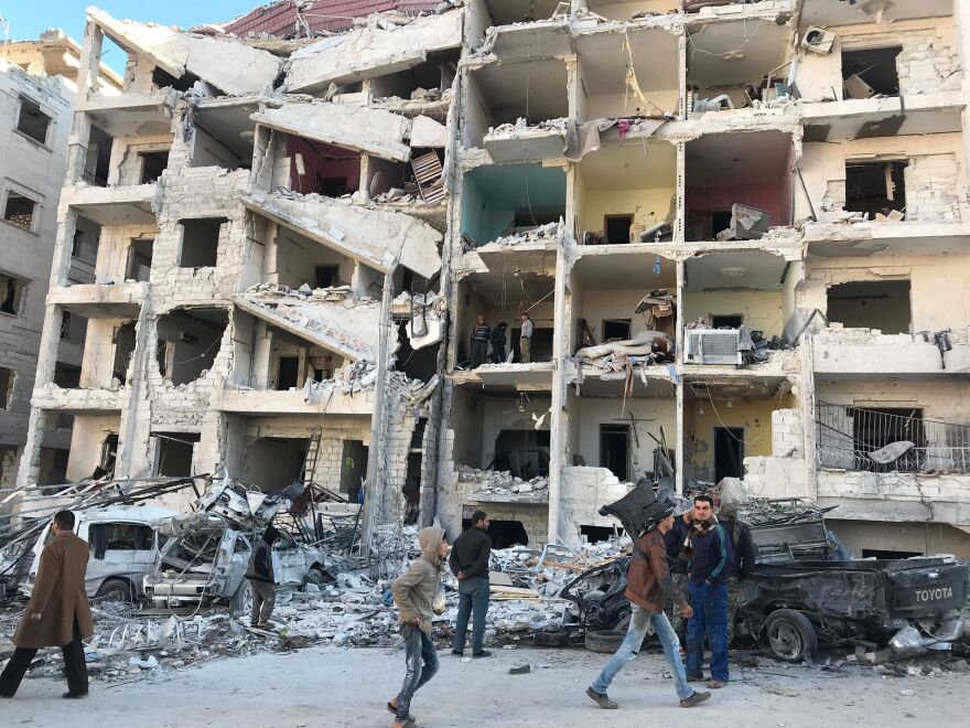 Looking at the damage in the aftermath of an explosion at in a rebel-held area of the northwestern Syrian city of Idlib on Monday.