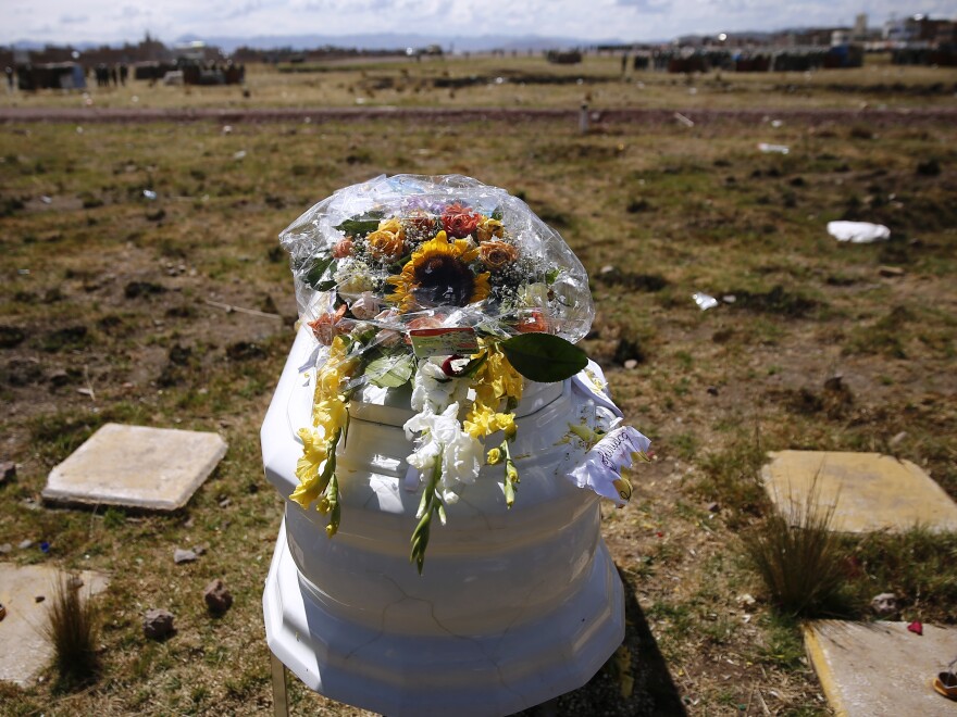 A coffin stands at the site where the deceased person was killed, during a funeral procession for protesters and others killed during clashes with police in Juliaca, Peru, Wednesday, Jan. 11, 2023.