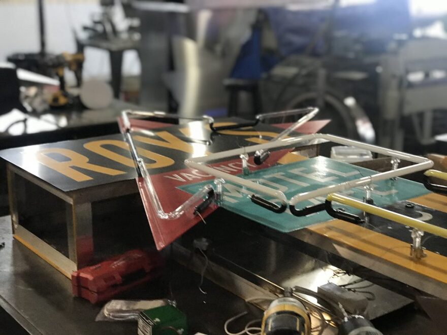 A neon sign being worked on by Fossil Forge.