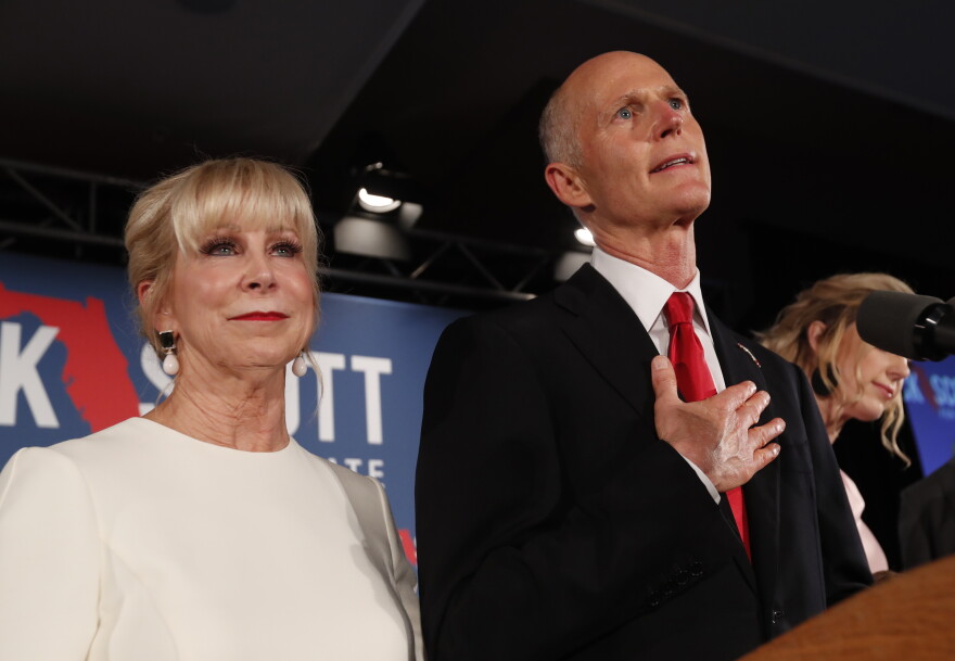 Republican Senate candidate Rick Scott speaks with his wife Ann by his side at an election watch party, Wednesday, Nov. 7, 2018, in Naples, Fla. 