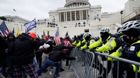 FILE - Violent insurrections loyal to President Donald Trump break through a police barrier at the Capitol in Washington on Jan. 6, 2021.