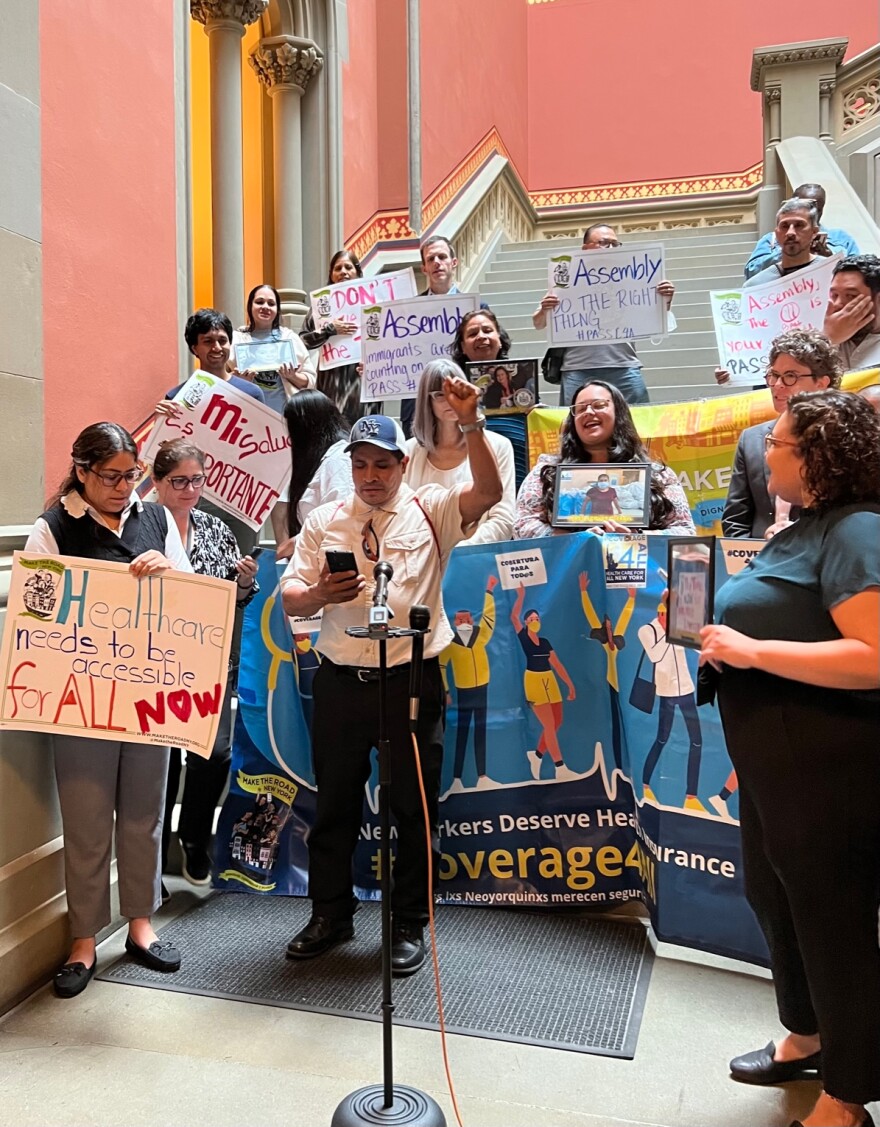  Juan Rosa, an immgrant with the advocacy group Make the Road, speaks in favor of the Coverage for All measure at a rally at the  State Capitol on June 20, 2023.  