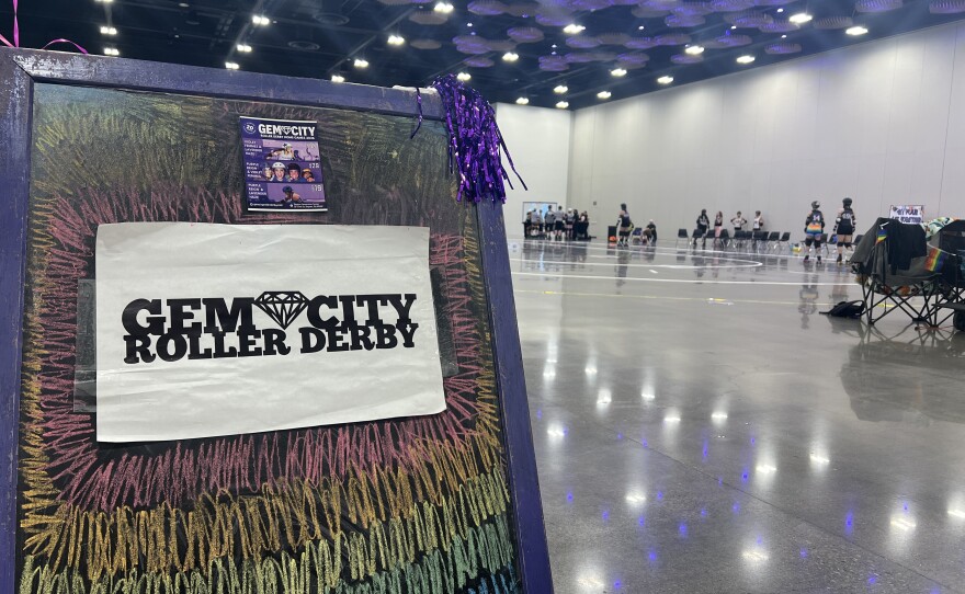 A chalkboard with the Gem City Roller Derby's logo surrounded by rainbow colors sits at the opening of the Dayton Convention Center's rental space