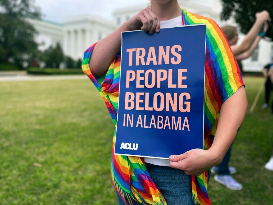 FILE - A person holds up a sign reading, "Trans People Belong in Alabama," during a rally outside the Alabama Statehouse in Montgomery, Ala., on International Transgender Day of Visibility, March 31, 2023. (AP Photo/Kim Chandler, File)