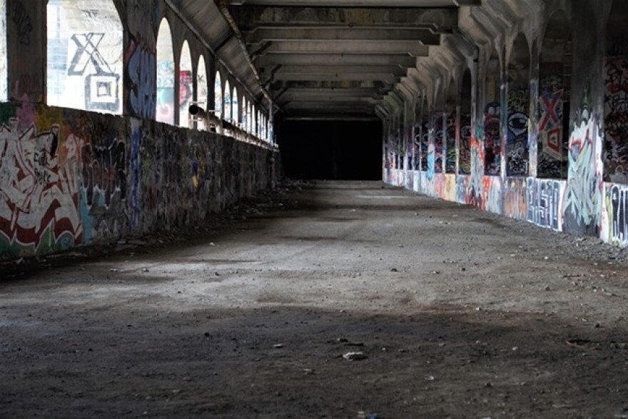 The aqueduct bed sits dormant, save its life as a canvas for graffiti artists.