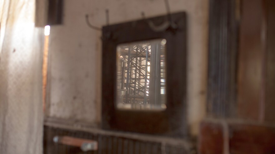 A mirror reflects the scaffolding that holds up the interior of the church.