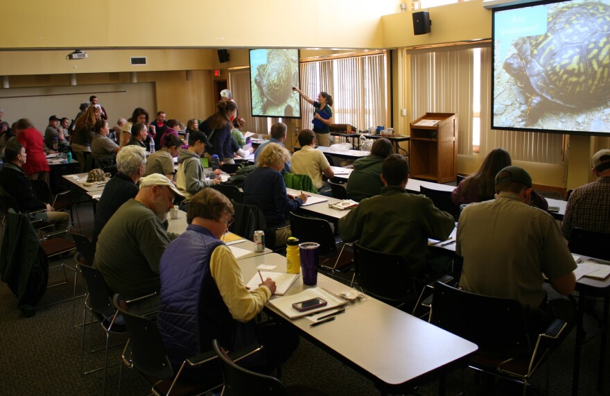 Gabrielle Graeter, a biologist with the North Carolina Wildlife Resources Commission, shows volunteers on how to properly fill out data sheets with box turtle information.