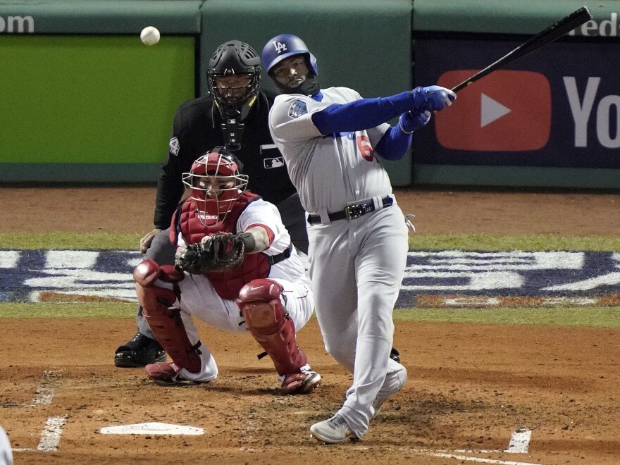 Red Sox reliever Nathan Eovaldi throws a strike to Dodgers Yasiel