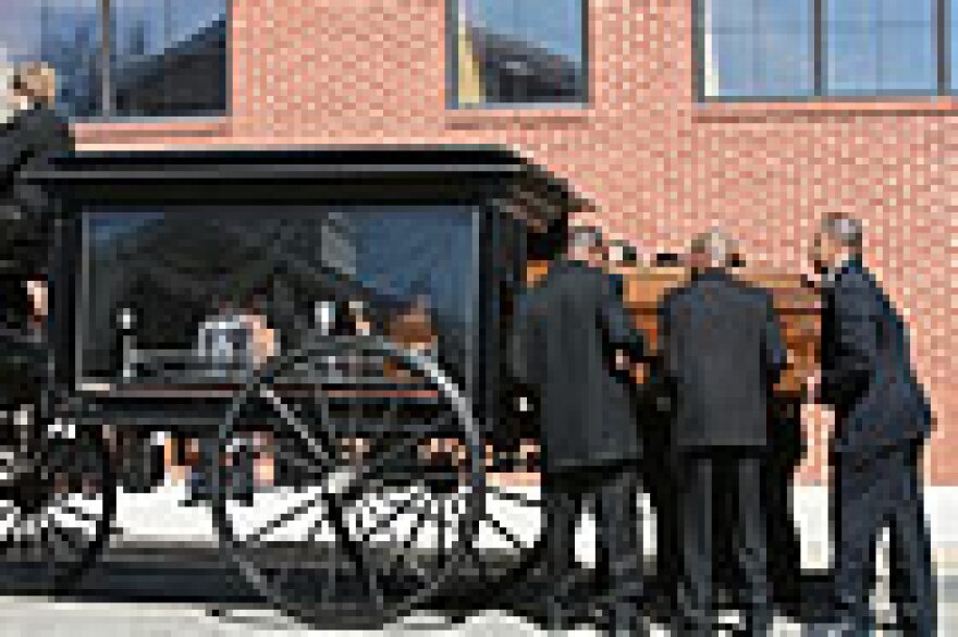 Pallbearers place the casket of Denver Broncos running back Damien Nash into a old style horsedrawn carriage for the three mile trip to a nearby cemetary in on Monday. (UPI Photo/Bill Greenblatt)