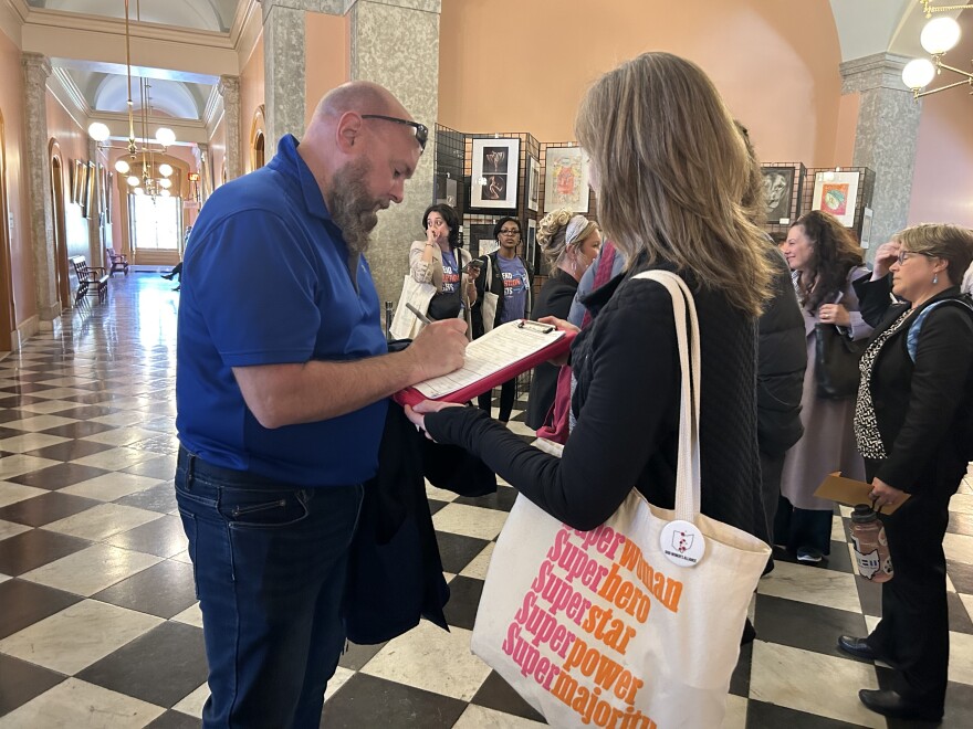 Petition circulator gathers signatures for Ohio reproductive rights petitions at the Ohio Statehouse