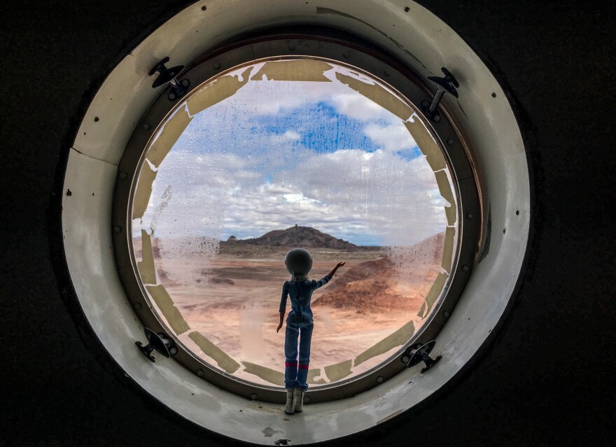 An astronaut Barbie waves from the habitat's porthole. LaBarre "rescued" the doll in a test of the crew's prototype emergency rover.