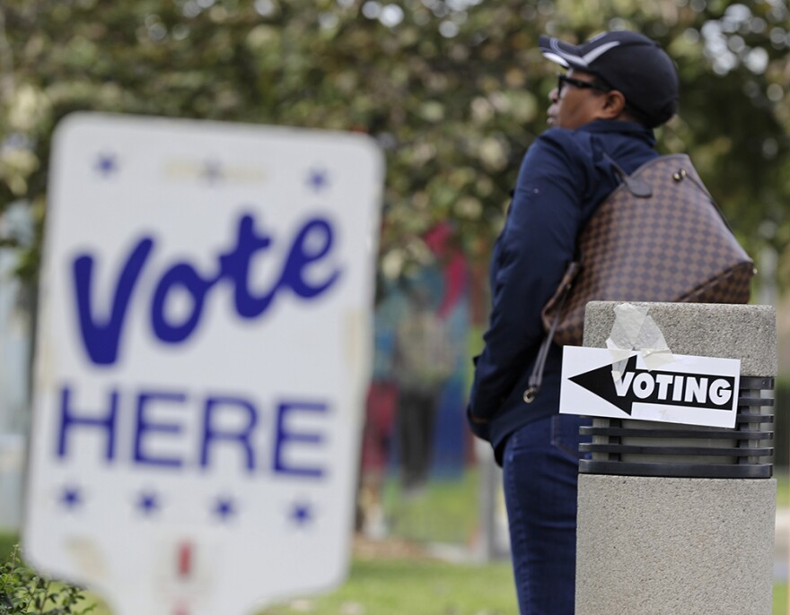 A woman arrives for early voting at a polling place in Charlotte, N.C., Tuesday, Oct. 23, 2018.