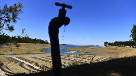 FILE - Water drips from a faucet near boat docks sitting on dry land at the Browns Ravine Cove area of drought-stricken Folsom Lake, in Folsom, Calif., on May 22, 2021. The sight of fountains, swimming pools, gardens and golf courses in Western cities like Phoenix, Los Angeles, Las Vegas, San Diego and Albuquerque can seem jarring with drought and climate change tightening their grip on the region. But Western water experts say they aren’t necessarily cause for concern. Many Western cities over the past three decades have diversified their water sources, boosted local supplies, and use water more efficiently now than in the past.(AP Photo/Josh Edelson, File)
