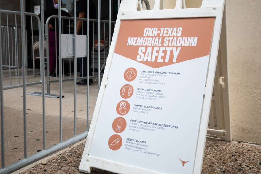 A sign outside Darrell K Royal-Texas Memorial Stadium outlines COVID-19 protocols for visitors.