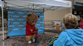 One of the event's small visitors gets neighborly with PBS Kids star Daniel Tiger.