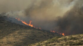Flames and smoke rise on a hillside above Twisp River Road near Twisp, Wash., Wednesday, Aug. 19, 2015.