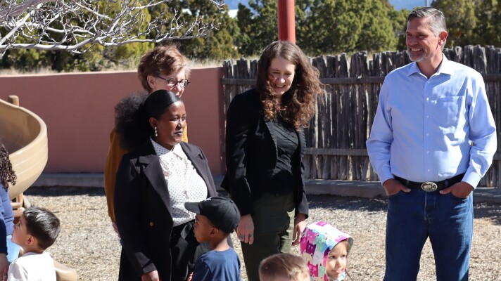 Aprende apprentice Etago Wondimu (left, foreground) said she wants to be a solution for New Mexico's lack of early childhood educators. U.S. Senator Martin Heinrich (D-NM) (right) toured SFCC's Kids Campus with Wondimu, SFCC President Becky Rowley (left, background) and Early Childhood Center of Excellence Executive Director Catron Allred (center).