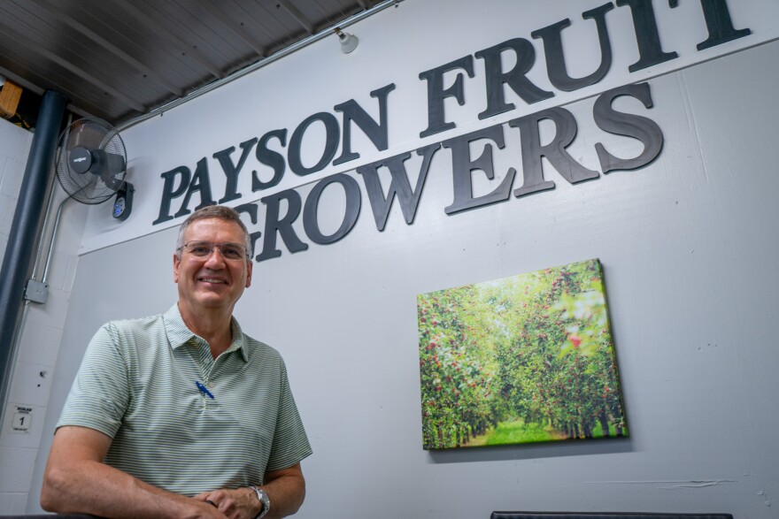 Chad Rowley poses in front of the Payson Fruit Growers sign in the front office of their Payson processing plant, July 24, 2026.