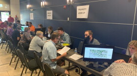 People sit at a line of computers to learn about property risk
