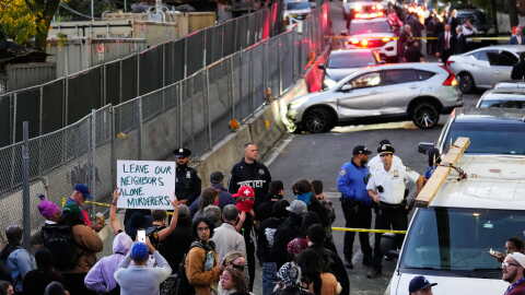 People gather at the scene of a shooting as law enforcement work the area Thursday, Oct. 8, 2026, in New York.