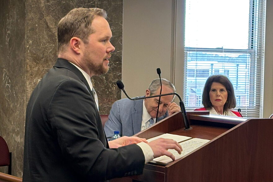 Energy Alabama Executive Director Daniel Tait speaks into a microphone behind a podium.