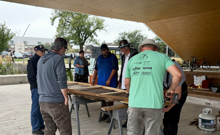 Ron J. Paquin, his apprentices and volunteers building the birch canoe.
