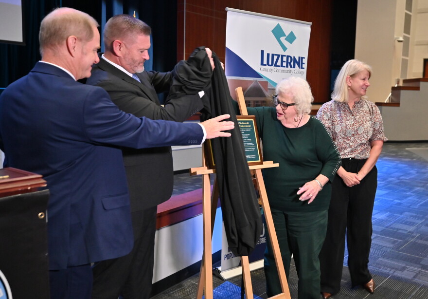 Wilkes-Barre Area Superintendent Brian Costello, Luzerne County Community College President John Yudichak, Angeline Kotlowski and Carol Keup uncover a plaque in honor of Angeline and Conrad Kotlowski.