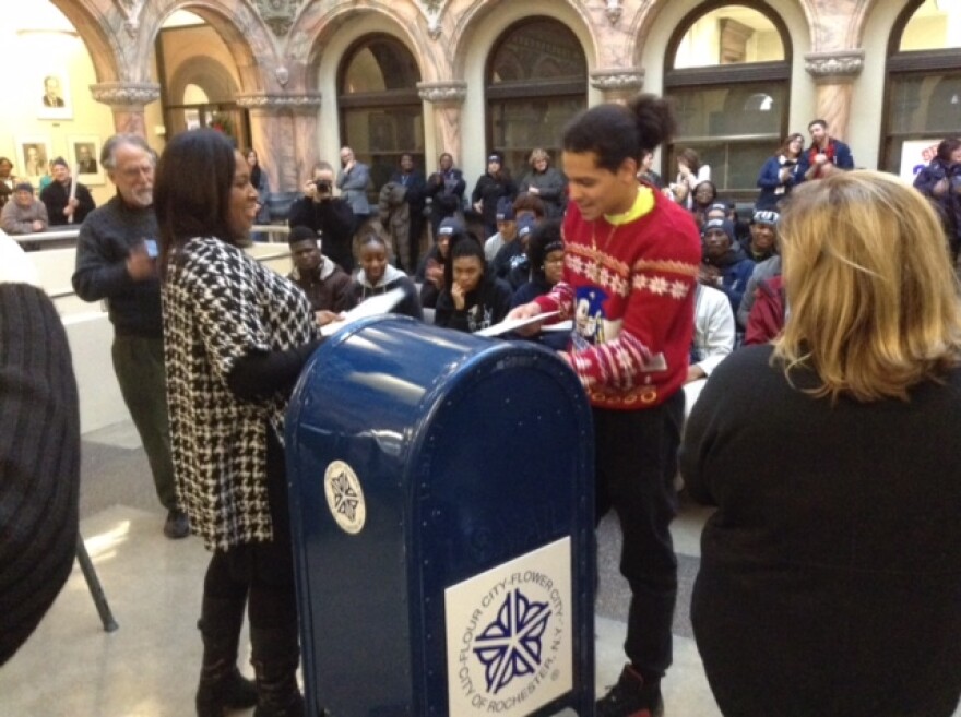Students mailing their letter of intent, and letters of thanks, at City Hall during the College March