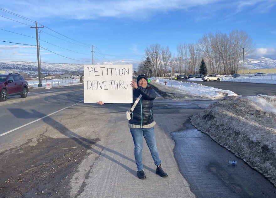 Lisa Meisner holds a sign in the Dark Skies petition drive Jan. 24.