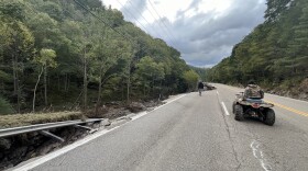 A man takes his off-road vehicle down a ruined road in Tennessee.