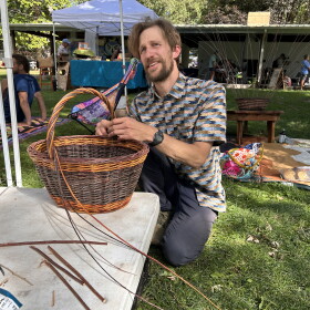 Artist Jeff Wagner weaving a basket at Mountain Harvest Festival.