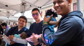 At a one-day workshop run by the Care School for Men in Bogotá, Colombia, male medical students at Sanitas University learn how to cradle a baby. This class of participants consists of medical students, but the usual enrollees are dads of all types.