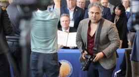 Jeremy Cubas shot photos of Gov. Mike Dunleavy on May 23, 2023 at the Alaska Sustainable Energy Conference in Anchorage. (Nathaniel Herz for Alaska Public Media)