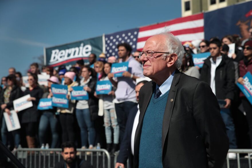 Democratic presidential candidate Sen. Bernie Sanders (I-VT) listens as Rev. Jesse Jackson addresses the crowd during Sander's campaign rally in Calder Plaza in Grand Rapids, Michigan.